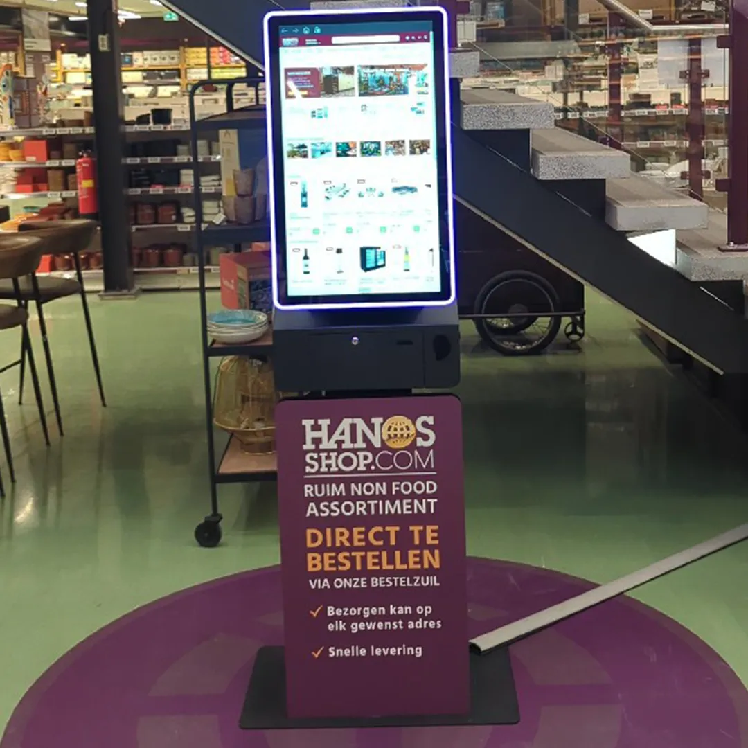 HANOS SHOP order kiosk in a branch, designed and supplied by Prestop, with custom poster plate and integrated software.